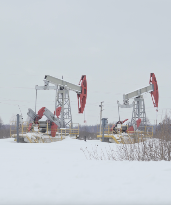 Russian pumpjacks in a winter field.
